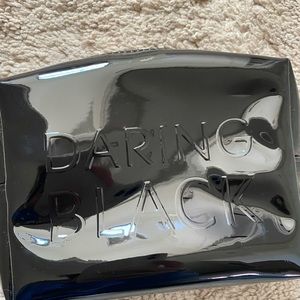 This is a Saint Laurent (YSL) Daring Black makeup bag.